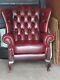 Chesterfield An Oxblood Winged Button Back Fireside Chair On Cabriole Legs