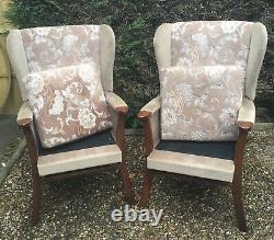 Matching pair of high back wingback fireside floral armchairs