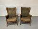 Pair Of Vintage Green Fabric Wing Back Fire Side Armchairs With Wooden Legs