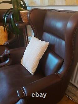Traditional fireside chair, upholstered in a rich brown leather (Single Chair)